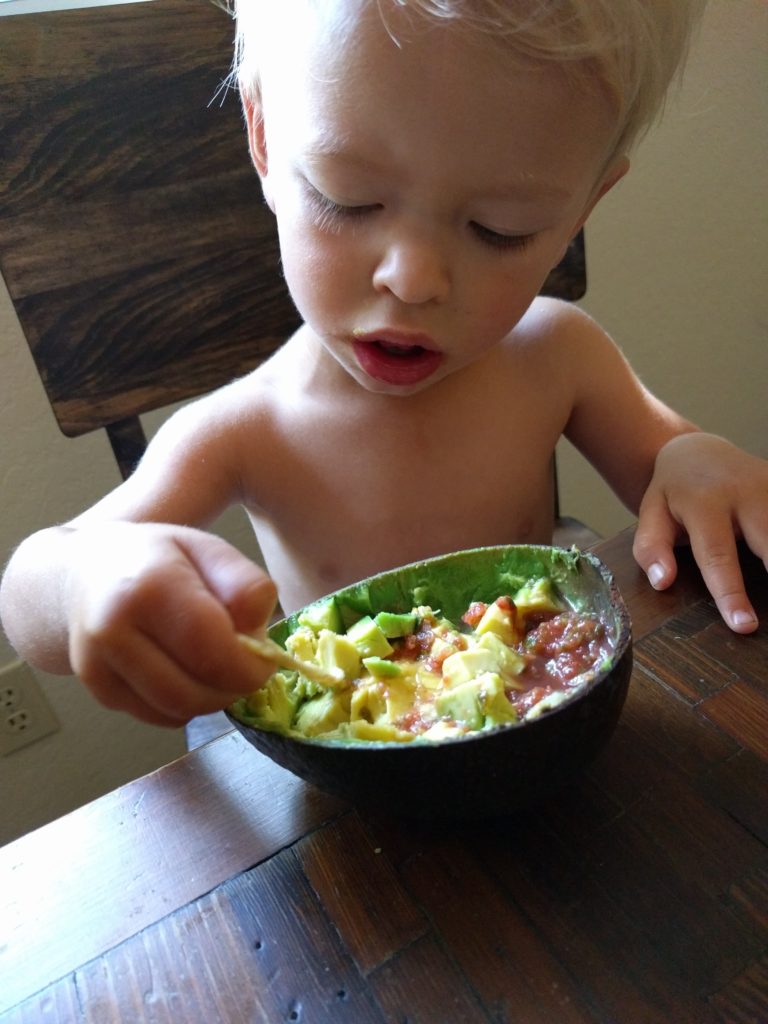 eating a Reed avocado personal bowl of guacamole